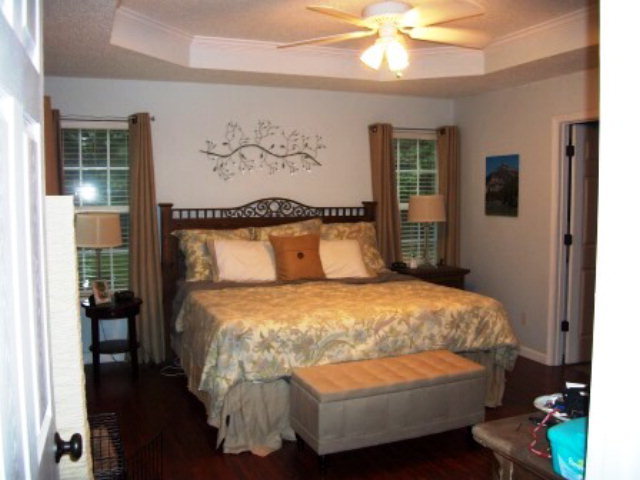 103 Craig Road Forsyth, GA 31029 - Photo 6 of 13 a bedroom with a bed and a chandelier
