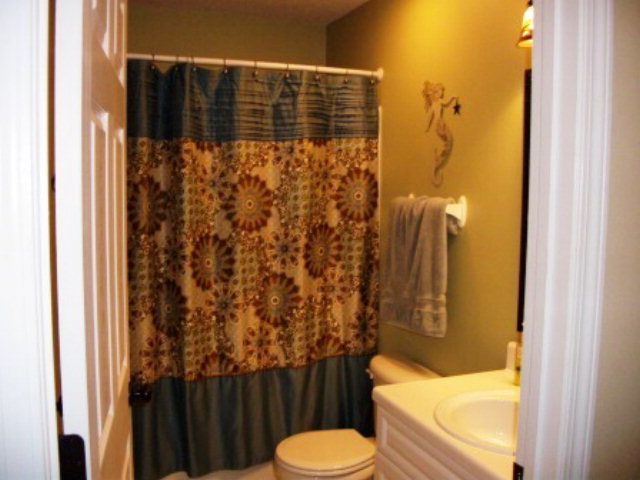 103 Craig Road Forsyth, GA 31029 - Photo 9 of 13 a bathroom with a toilet and shower curtain