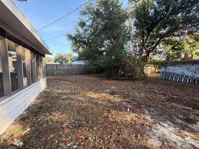 a view of a backyard with a tree
