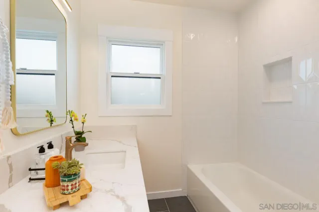 an empty room with wooden floor and a window