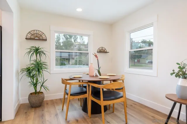 a view of a dining room with furniture window and wooden floor