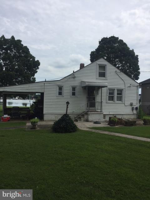 1035 Chester Road Baltimore, MD 21220 - Photo 2 of 7 a front view of a house with garden and trees