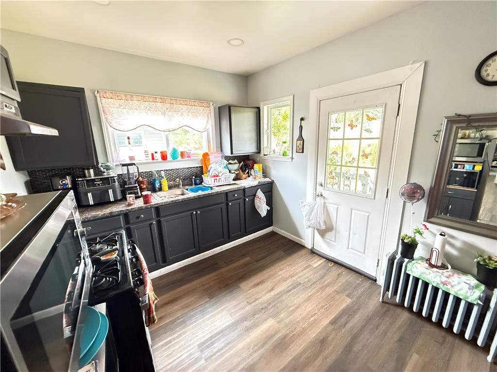 700 Philo Street Scranton, PA 18508 - Photo 7 of 19 Functional kitchen with dark cabinetry and durable wood-look flooring, perfect for daily meal preparation.