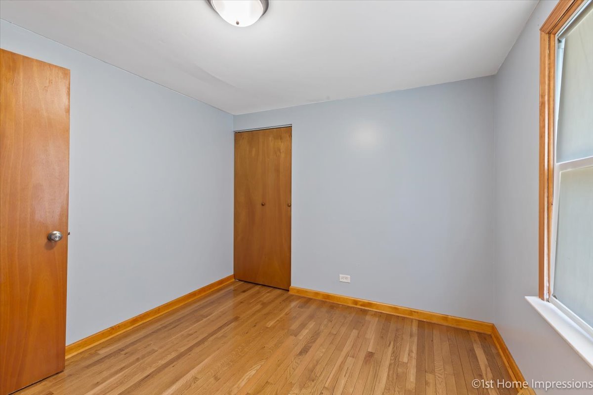 16640 Marshfield Avenue Markham, IL 60428 - Photo 13 of 20 a view of an empty room with window and wooden floor