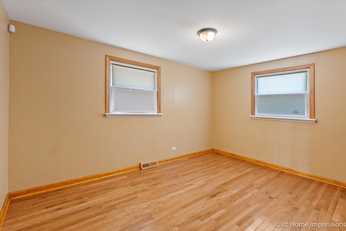 16640 Marshfield Avenue Markham, IL 60428 - Photo 14 of 20 a view of an empty room with wooden floor and a window