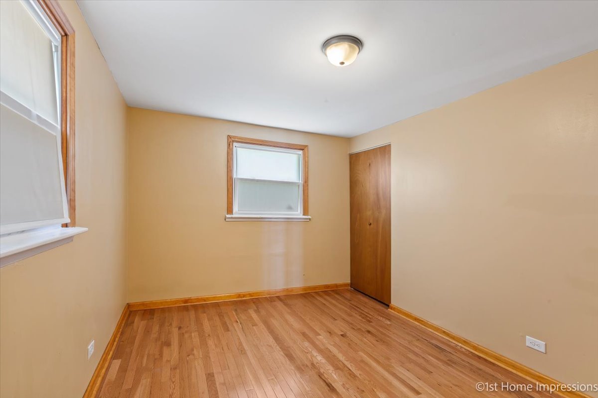 16640 Marshfield Avenue Markham, IL 60428 - Photo 15 of 20 an empty room with wooden floor and windows