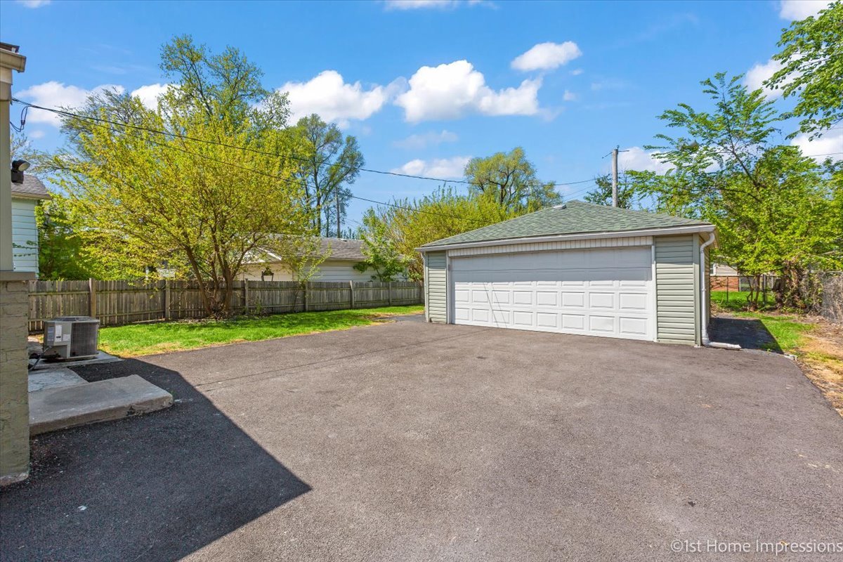 16640 Marshfield Avenue Markham, IL 60428 - Photo 17 of 20 a view of a house with a yard and garage