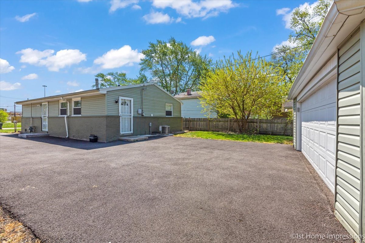 16640 Marshfield Avenue Markham, IL 60428 - Photo 20 of 20 a view of a house with a backyard and a garage