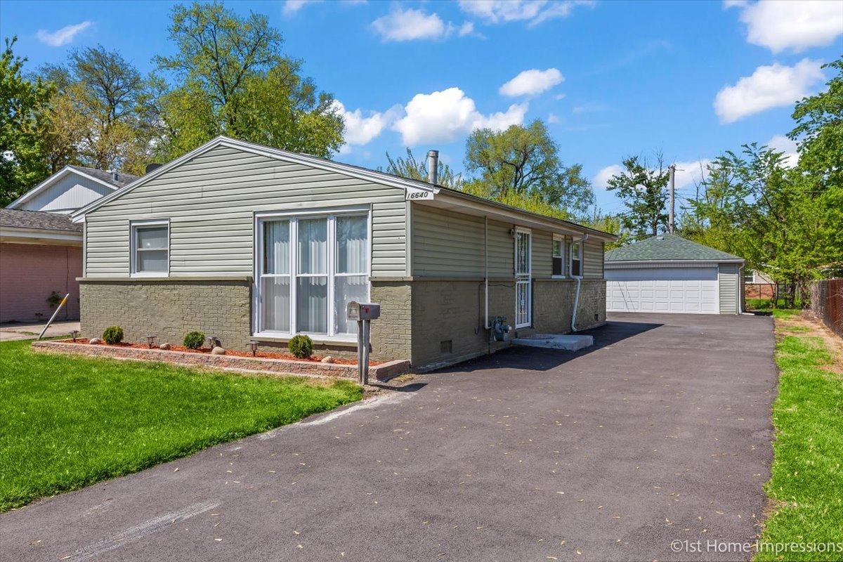 16640 Marshfield Avenue Markham, IL 60428 - Photo 2 of 20 a front view of a house with a yard and garage
