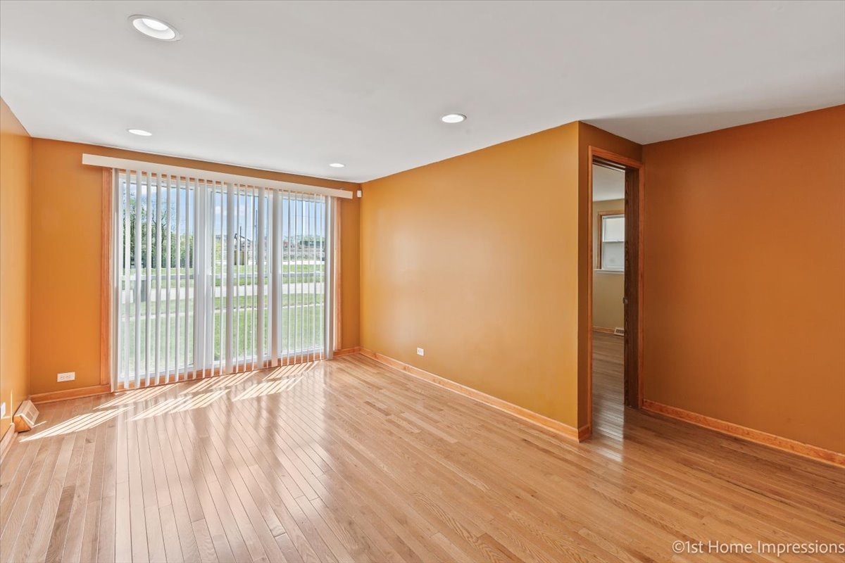 16640 Marshfield Avenue Markham, IL 60428 - Photo 6 of 20 wooden floor in an empty room with a window
