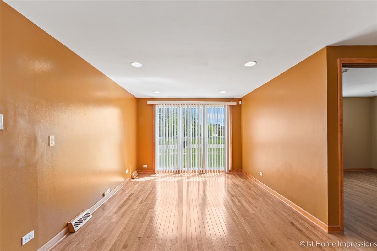 16640 Marshfield Avenue Markham, IL 60428 - Photo 7 of 20 a view of an empty room with wooden floor and a window