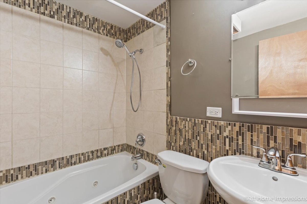 16640 Marshfield Avenue Markham, IL 60428 - Photo 9 of 20 a bathroom with a sink a toilet and shower
