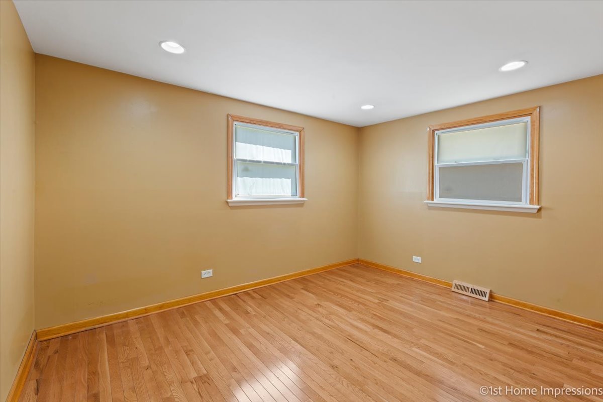 16640 Marshfield Avenue Markham, IL 60428 - Photo 10 of 20 a view of an empty room with wooden floor and a window