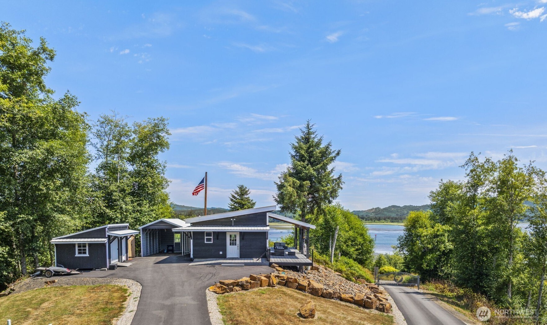 a front view of a house with a garden and yard