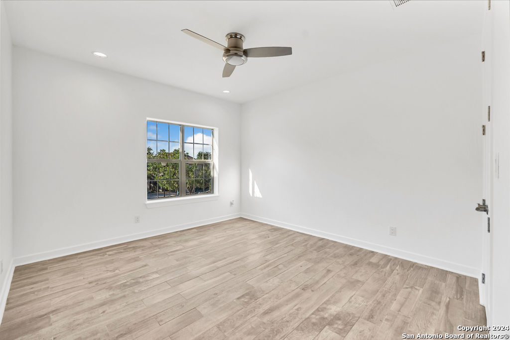 1303 Summerfield San Antonio, TX 78258 - Photo 16 of 27 wooden floor in an empty room with a window