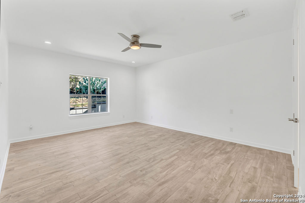 1303 Summerfield San Antonio, TX 78258 - Photo 20 of 27 an empty room with windows and ceiling fan