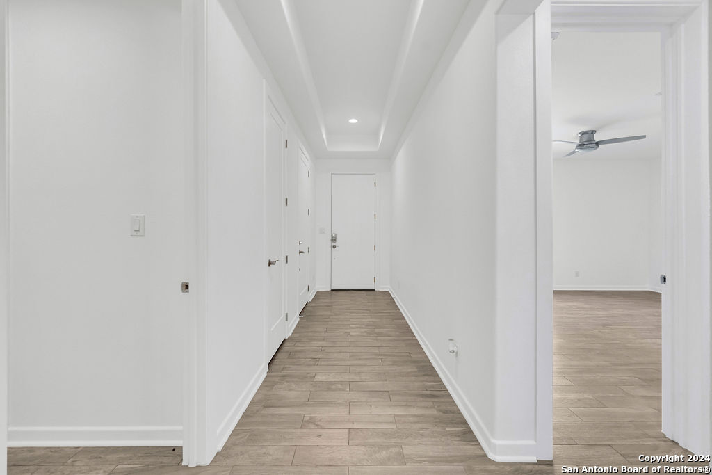1303 Summerfield San Antonio, TX 78258 - Photo 25 of 27 a view of a hallway with wooden floor and a bathroom
