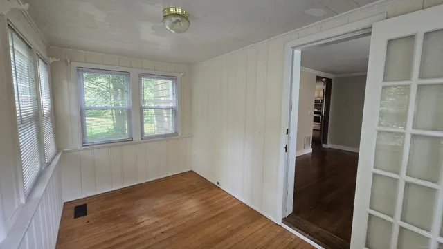 wooden floor in an empty room with a window
