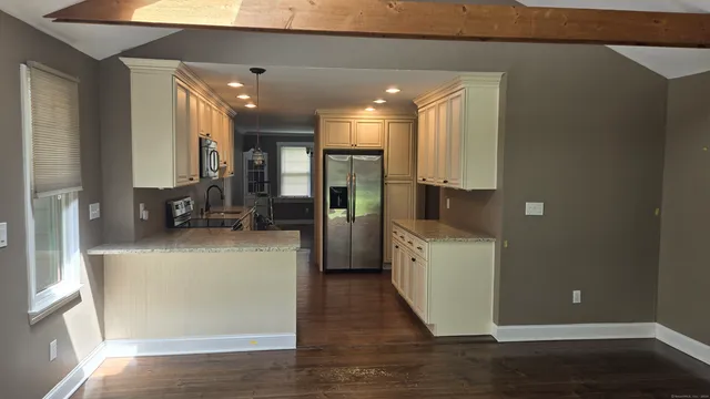 a view of a kitchen with a refrigerator a stove top oven a sink and dishwasher