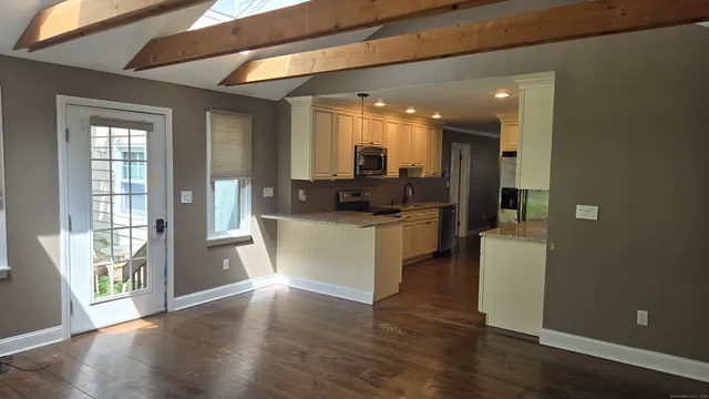 a view of kitchen with furniture and wooden floor