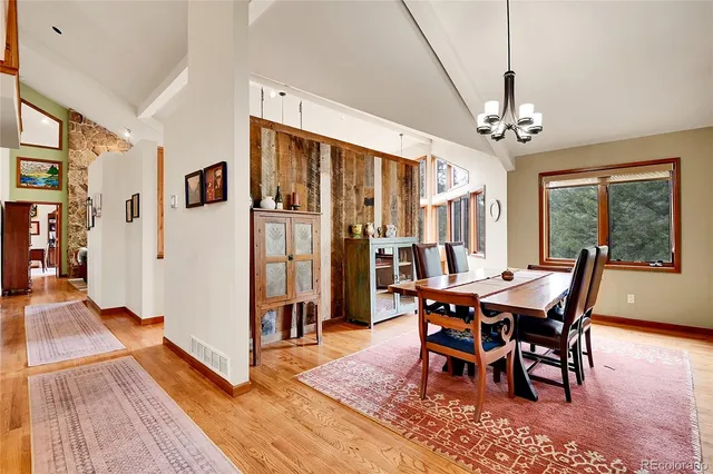 a view of a dining room with furniture window and wooden floor