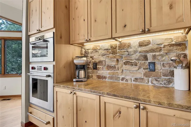 a kitchen with granite countertop a sink and a stove