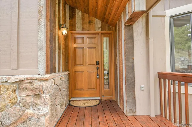 a view of a door with wooden floor and a bathroom