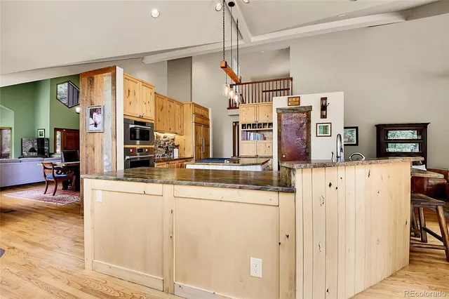 a kitchen view with stainless steel appliances granite countertop a sink and cabinets