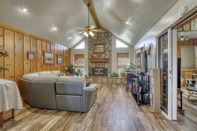 a living room with furniture a flat screen tv and a fireplace