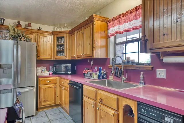a kitchen that has a lot of cabinets in it and wooden floors
