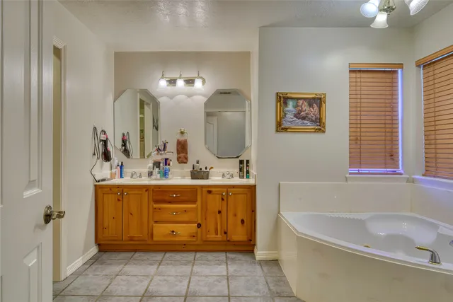 a bathroom with a tub sink and mirror
