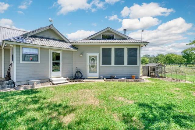 a front view of a house with a yard table and chairs