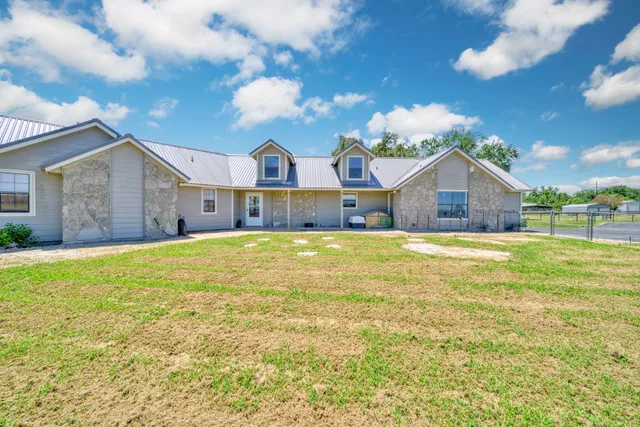 a house view with a swimming pool next to a yard