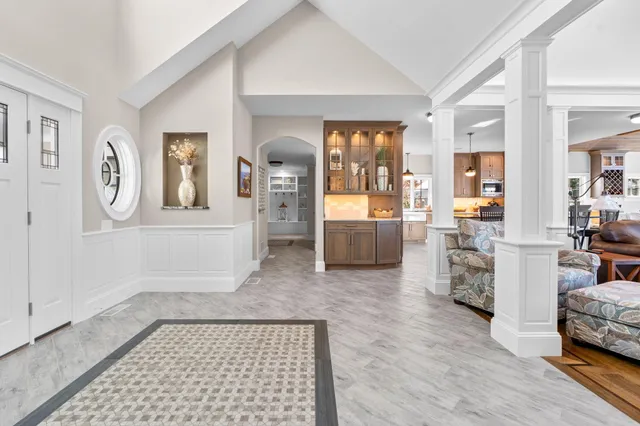 a kitchen with stainless steel appliances a dining table chairs stove and refrigerator