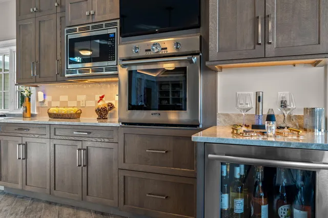 a bathroom with a granite countertop toilet sink and mirror
