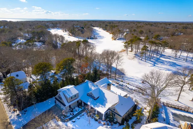 a view of a porch with chairs and potted plants