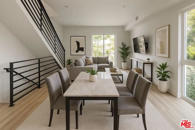 a view of a a dining room with furniture window and wooden floor