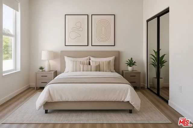 a bedroom with a bed and a potted plant