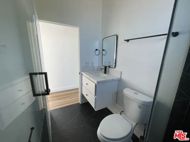 a white toilet sitting next to a bathroom sink