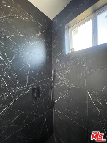 a bathroom with a shower and a sink