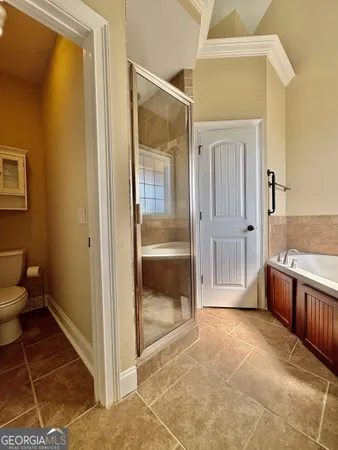 a bathroom with a tub and shower