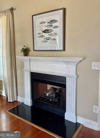 a living room with a fireplace and a painting on the wall