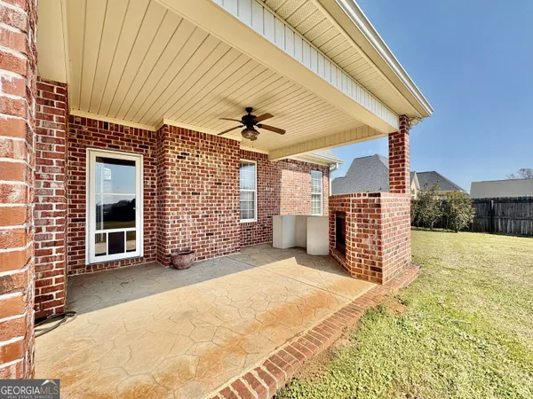 a view of a livingroom with wooden floor and a ceiling fan