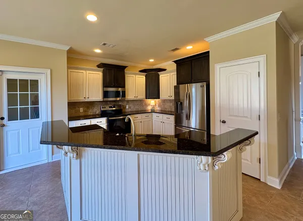 a kitchen with stainless steel appliances a refrigerator and a stove top oven