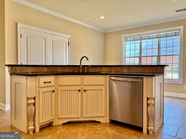 a view of a kitchen with a sink and a window