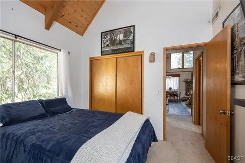 a bedroom with a bed and a large window