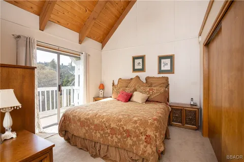 a bedroom with a large bed and a window