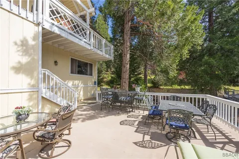 a view of a chair and tables in the balcony