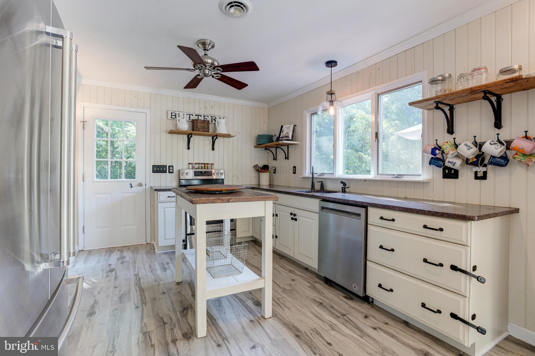 933 Monkton Road Monkton, MD 21111 - Photo 15 of 48 a kitchen with granite countertop a stove cabinets and wooden floor