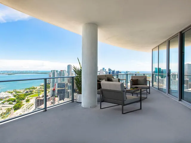 a balcony with furniture and city view